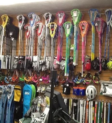 Lacrosse sticks and equipment on display at Sports Barn