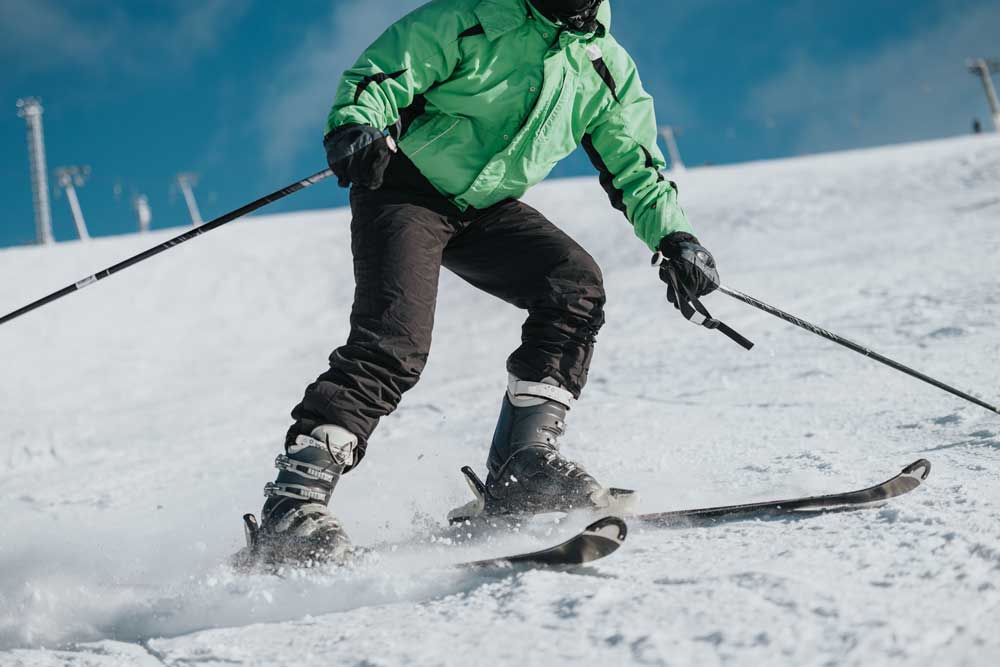 Skier carving down a snowy mountain slope
